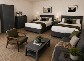 A hotel room with two beds, a sofa, a chair, a small table, and a cabinet. - Huge  Home Near Times Square (New York)