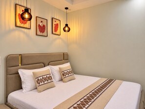 Une chambre d’hôtel avec un grand lit, une tête de lit et deux appliques murales.