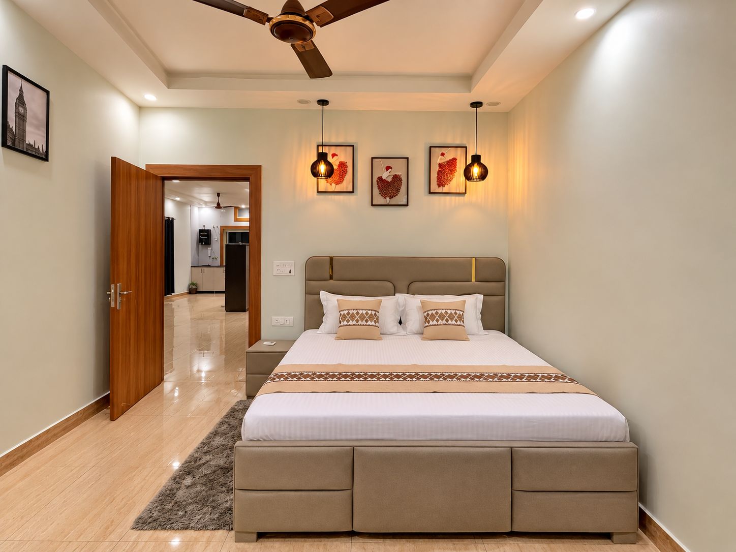 A bedroom with a bed, bedside tables, a ceiling fan, and artwork on the wall.
