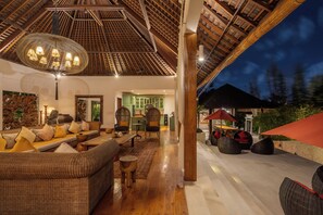 A spacious living area with a high ceiling, wicker furniture, and a view of the outdoors. - Villa Naty Luxury 6 Bedrooms Near Canggu (Bali)