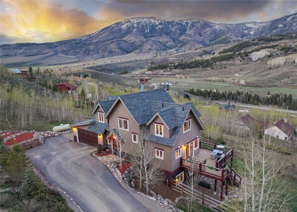 A two-story house with a garage, a deck, and a driveway. - 947 Blue Ridge 4 Bedroom Home (Silverthorne)