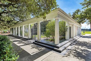 A covered pavilion with columns, a gated entrance, and a pathway leading to it. - Charming Victorian 2BR Near Forsyth (Savannah)