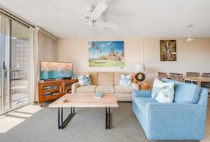 A living room with a television, sofa, coffee table, and a ceiling fan. - Mana Kai 310: 2  BR, 2  BA Condominium in Kihei, Sleeps 4 (Kihei)