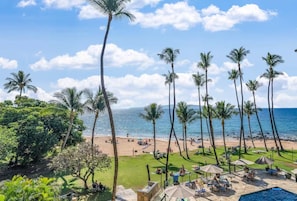 A beach resort with palm trees, a pool, and a view of the ocean. - Mana Kai 310: 2  BR, 2  BA Condominium in Kihei, Sleeps 4 (Kihei)