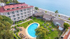 A hotel with a swimming pool, a beach, and a view of the sea. - Hotel Mutlu (Fethiye)