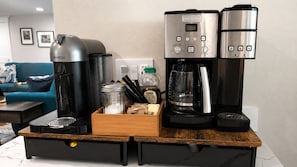 A kitchenette with a coffee maker, a water dispenser, and a coffee grinder. - Serene Kenmore Stay - 2BR, Patio & Parking (Kenmore)