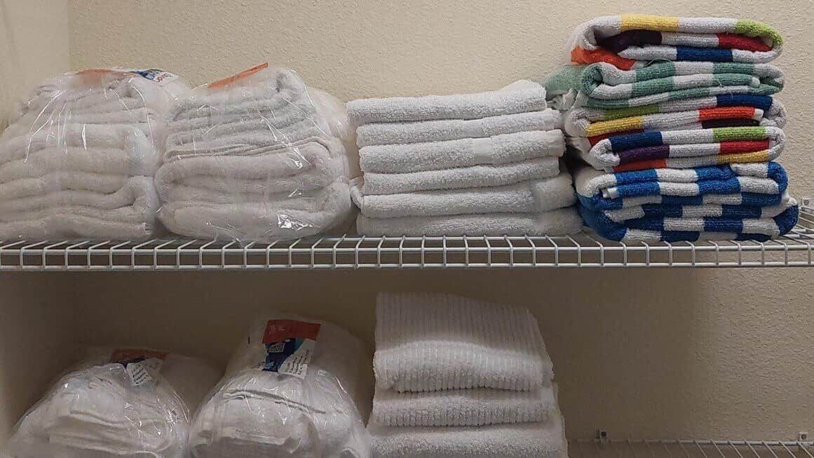 A storage shelf with towels and bath linens.