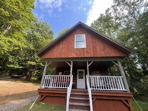 A wooden cabin with a porch, a door, and a window. - Floyd cabin (Dansville)