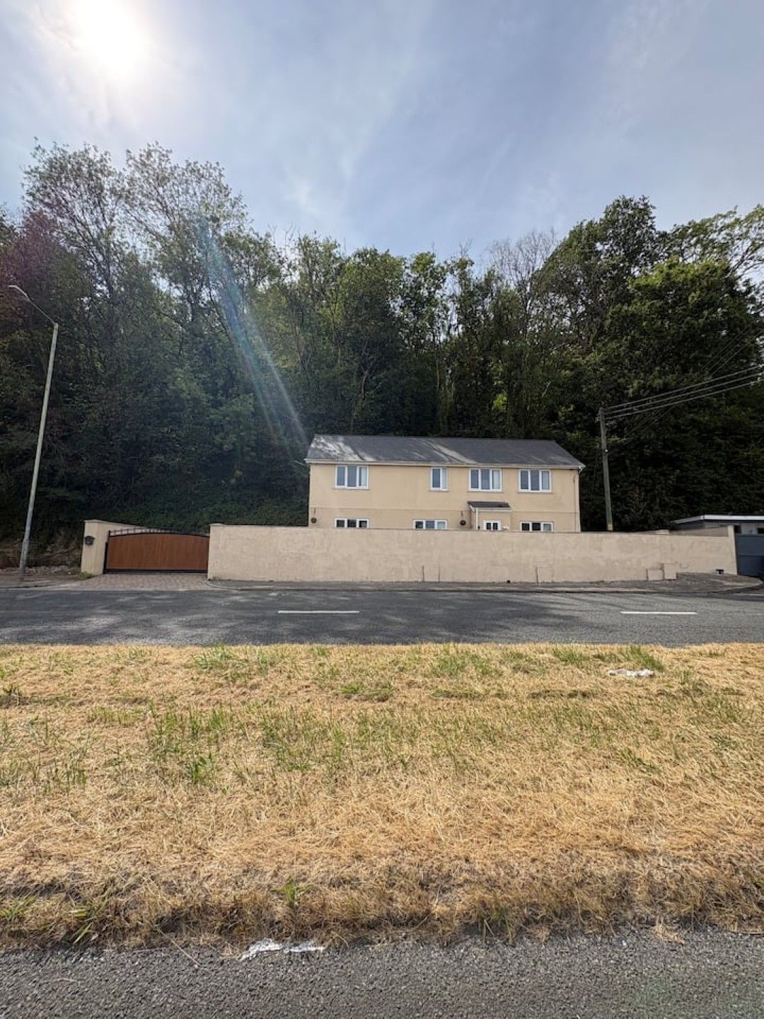 A two-story building with a flat roof, a garage, and a driveway.