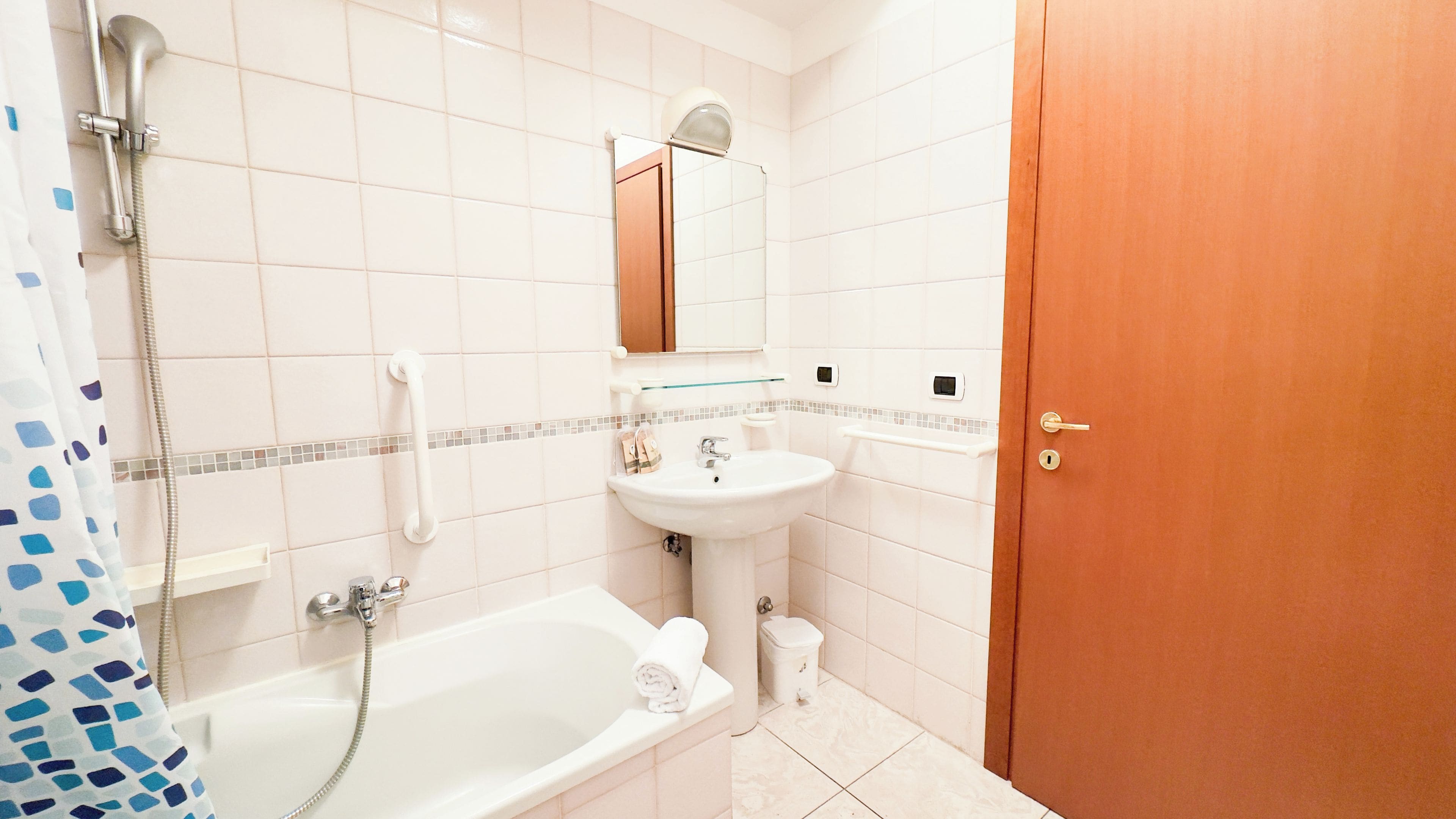A bathroom with a bathtub, a sink, a toilet, and a shower.