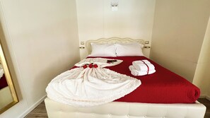 A hotel room with a bed, white bedding, a red blanket, and a white bathrobe. - Graceful Venice Barnaba Suite by Ca-sa Check (Venice)
