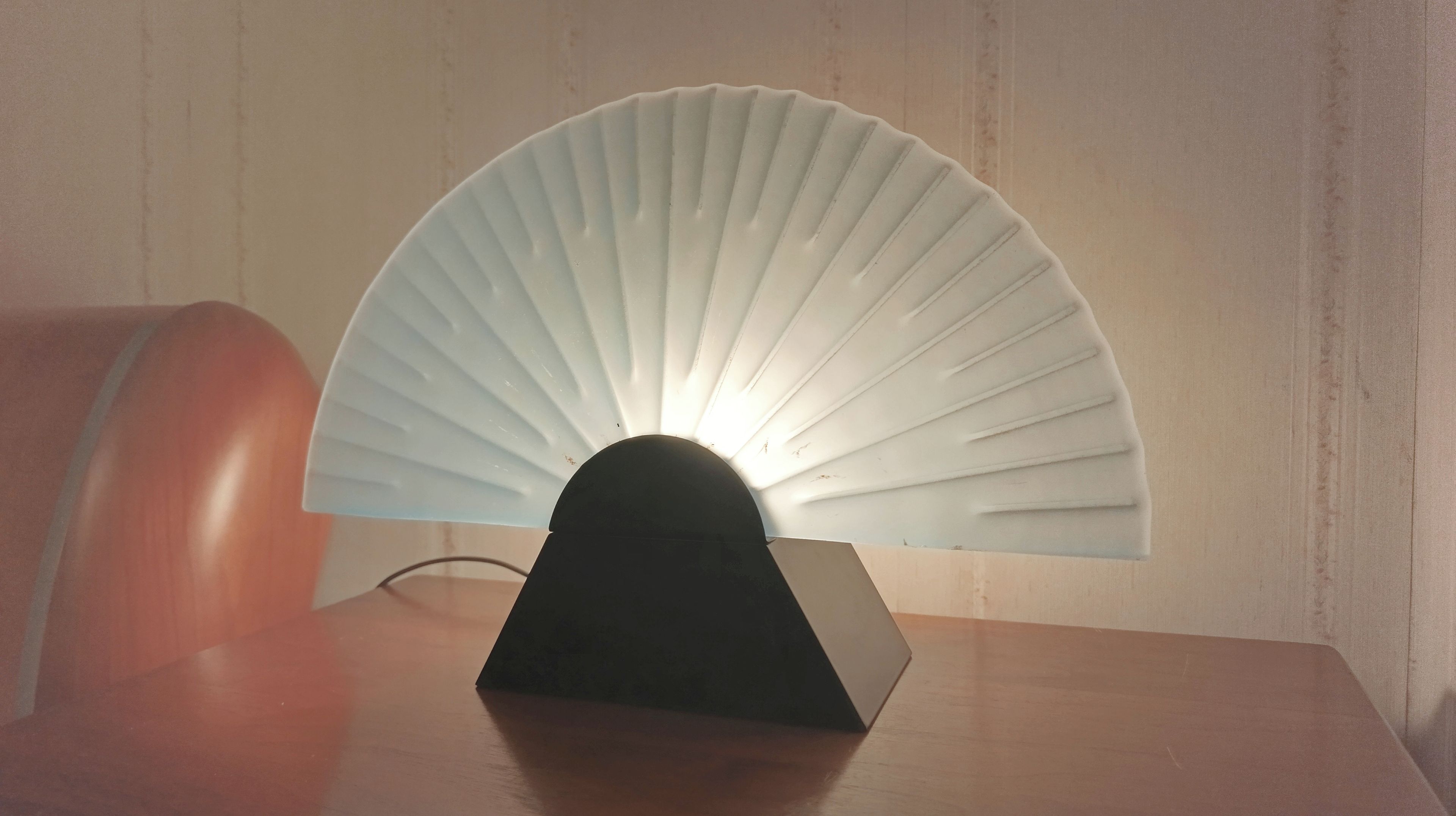 A table with a fan-shaped light fixture on top.