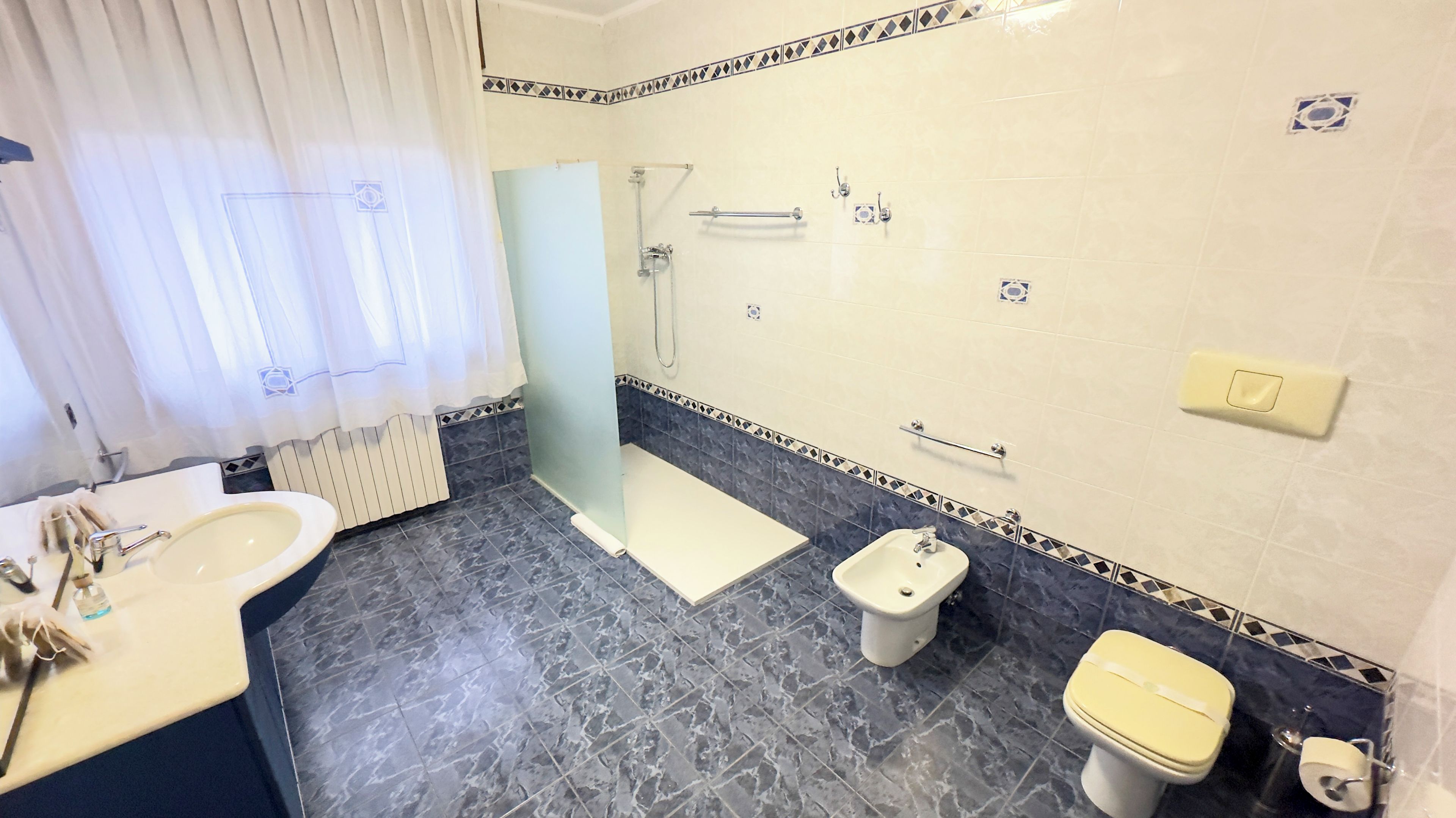 A bathroom with a bathtub, a shower, a toilet, and a bidet.
