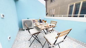 An outdoor dining area with a table set for two, surrounded by chairs. - Ca' Egle by Ca-sa Check (Chioggia)