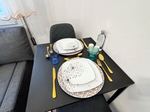 A dining table set with plates, cutlery, and glasses, with a patterned table runner. - Casa Angela by Ca-sa Check (Chioggia)