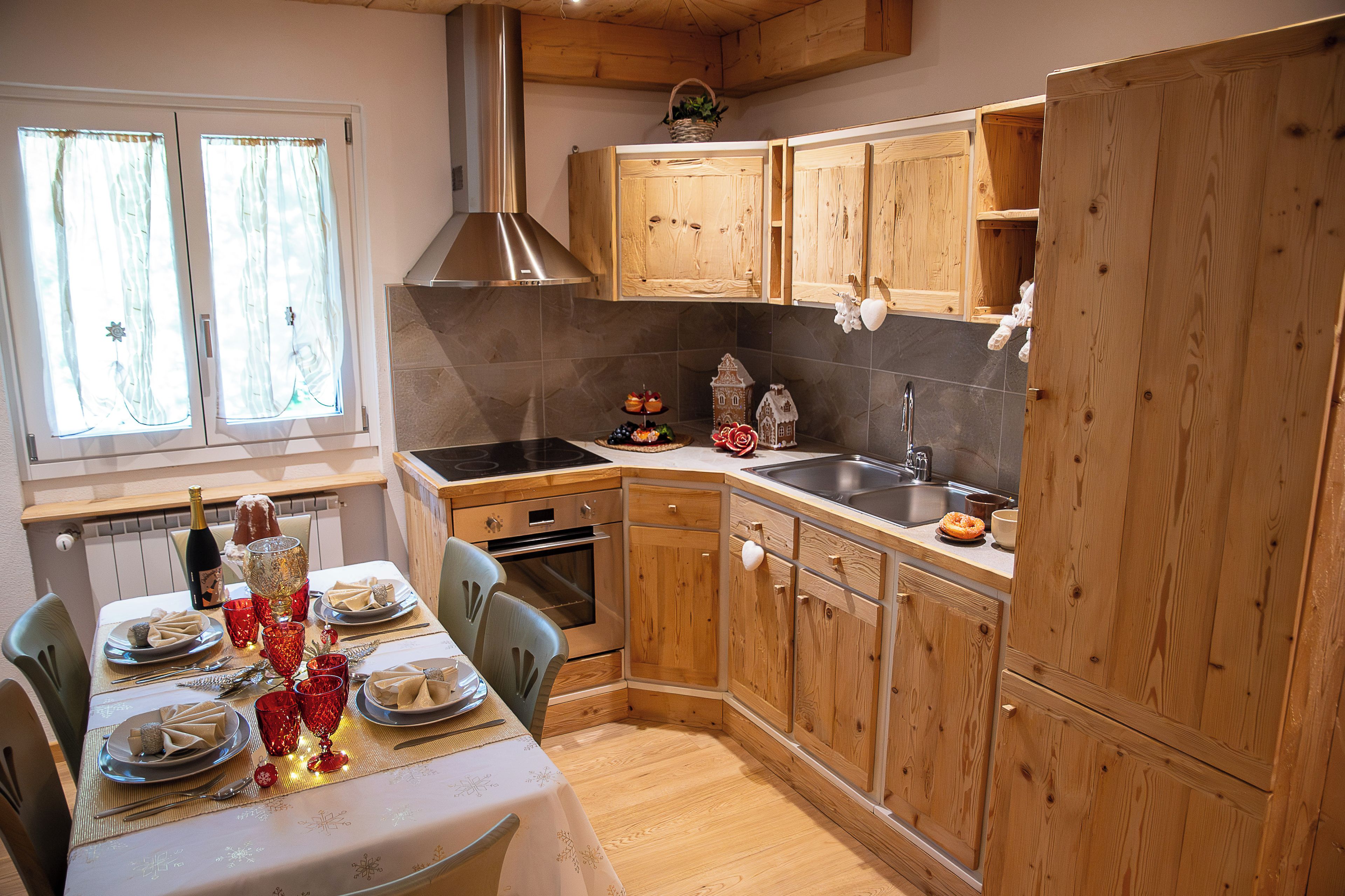 A kitchen with wooden cabinets, a stove, and a sink.