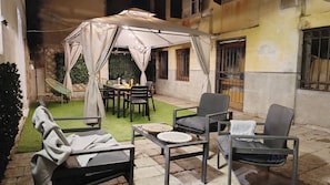 An outdoor patio with a dining table, chairs, and a covered seating area. - Casa Anna by Ca-sa Check (Venice)
