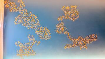 A wall with ornate golden patterns.
