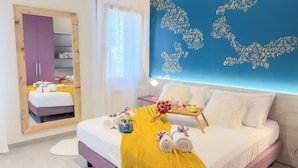 A hotel room with a bed, a vanity with a mirror, a wardrobe, a bedside table with a lamp, and a decorative wall. - Velvet Suite by Ca-sa Check (Chioggia)