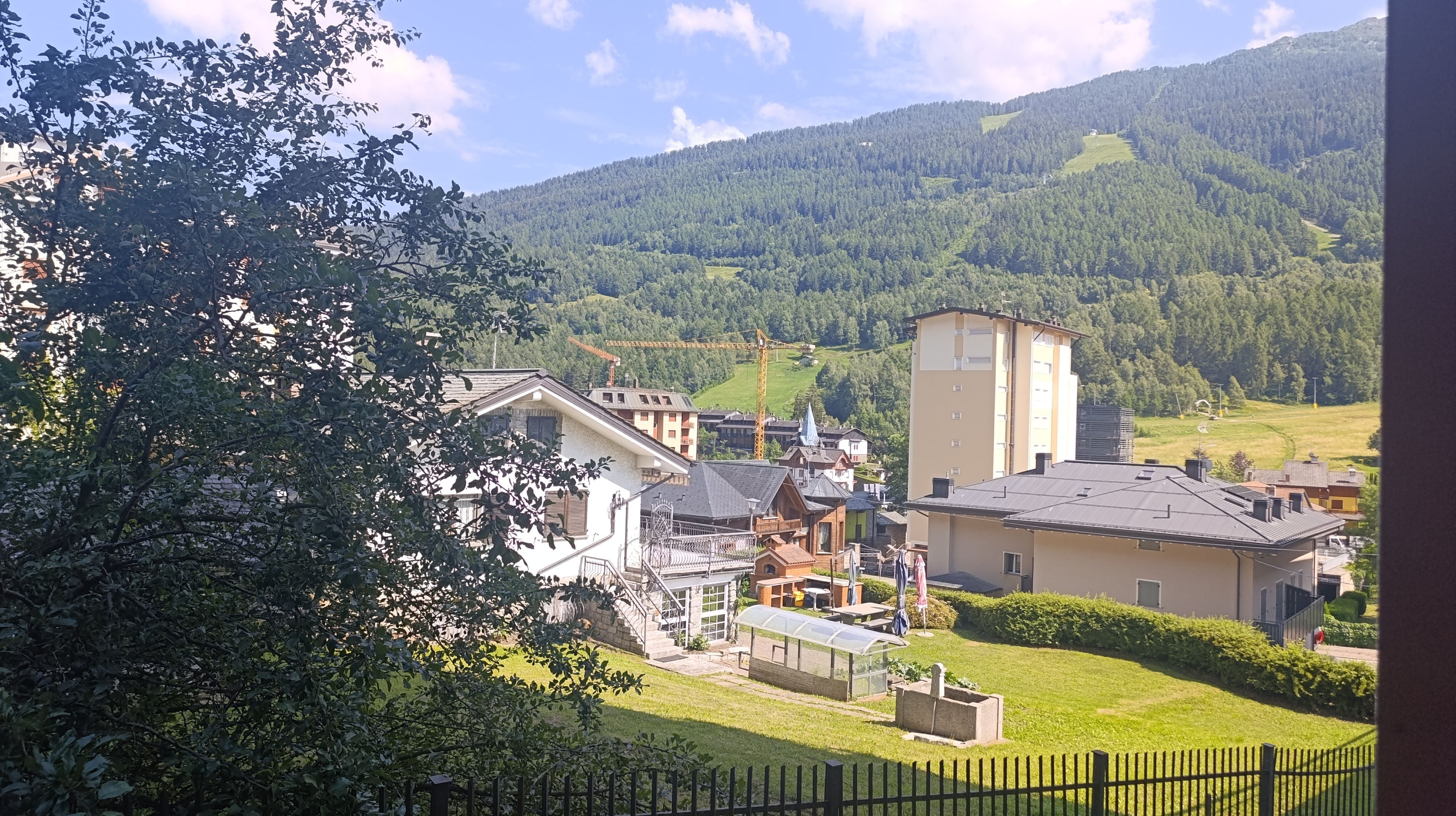A residential area with houses, a greenhouse, and a cemetery.