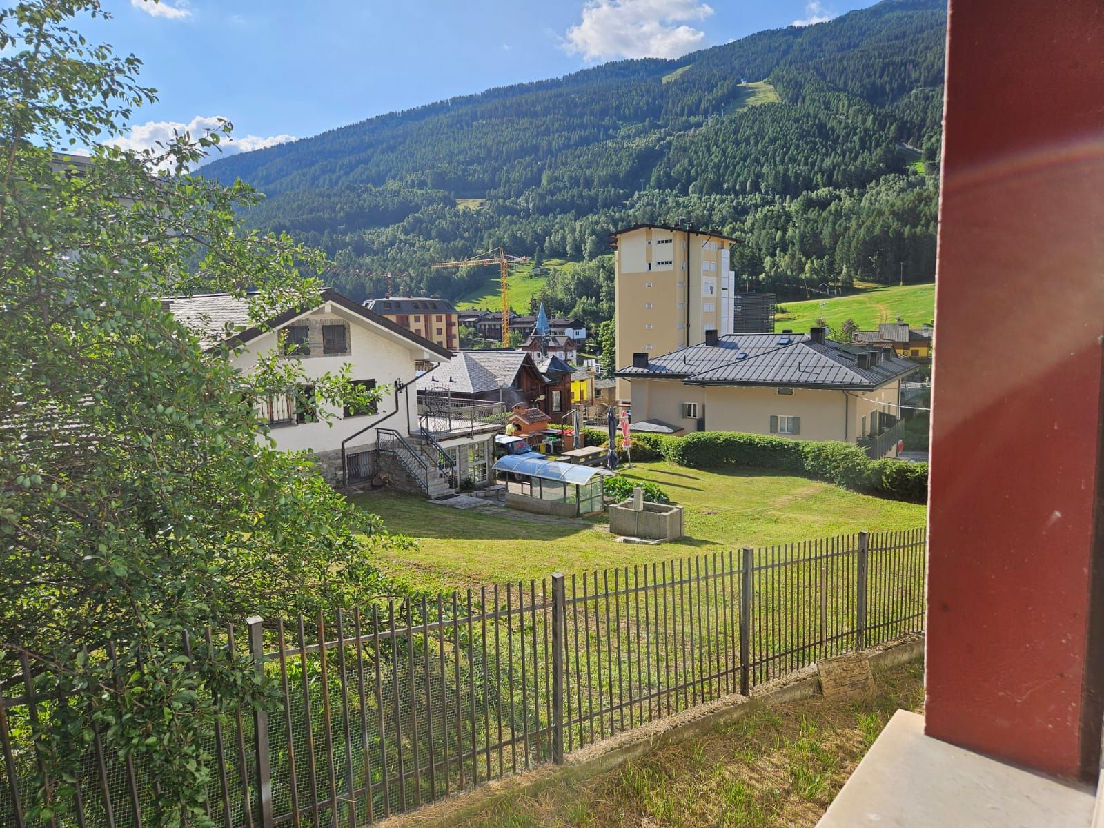 A rural village with houses, a church, and a mountain backdrop.