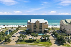 A beachfront hotel with a pool, parking, and a view of the beach and ocean. - Beachfront Condo with Stunning Gulf Views!  Gated, Balcony, Pool and Hot Tub! (Destin)