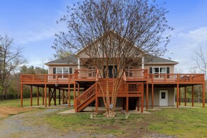 A two-story house with a wooden deck and a staircase leading to a balcony. - "TreeHouse" | Hot Tub | River Access | 20m to SNP (Front Royal)