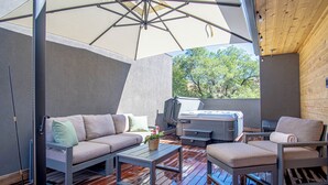An outdoor patio with a sofa, chairs, a table, and a grill. - River Street Lookout - Lux 3BD w/ Rooftop Views + Hot tub - Downtown Hailey (Hailey)