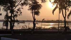 A sunset view with trees and a body of water. - Shrikrushna The Lakeview Resort  (Jalgaon)