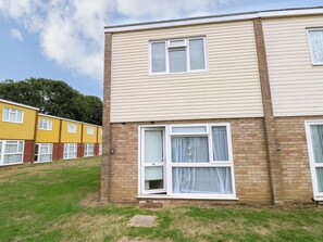 A two-story residential building with a brick facade and a flat roof. - Leaf Lodge (Great Yarmouth)