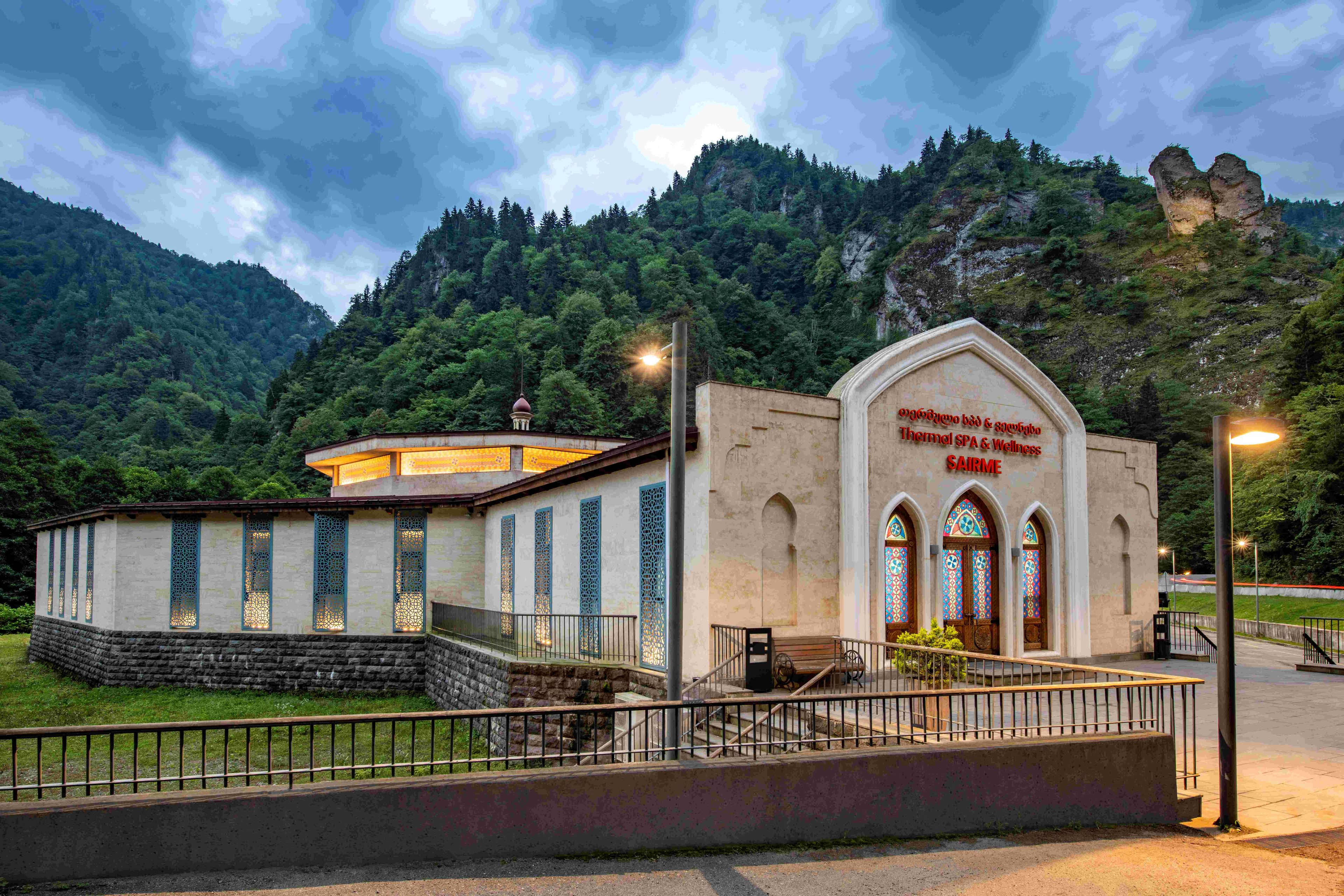 A building with a stone facade, a small dome, and a sign indicating it is a spa and wellness center.
