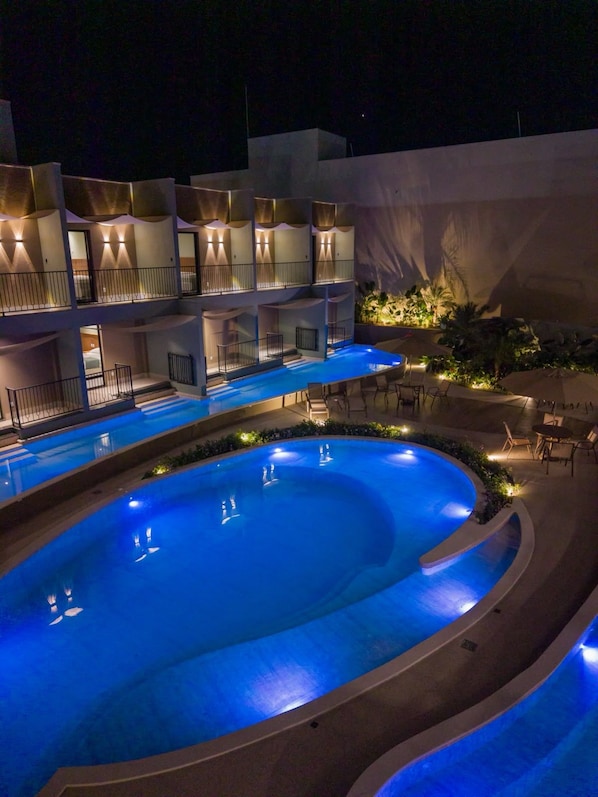 A multi-level hotel with a swimming pool and outdoor seating. - Essence Paradise Pousada Charme (Bonito)