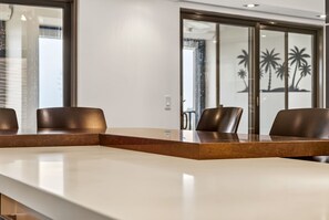 A conference room with a long table and four chairs. - The Wavefront | Gulf-front Executive Residence (St. Pete Beach)