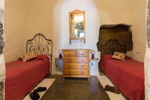A bedroom with two beds, a dresser, and a mirror. - Stay with Pool & View (Artenara)