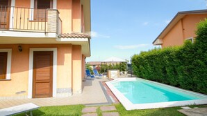A two-story building with a swimming pool, a covered patio area, and a well-maintained lawn. - Spacious Sicilian Etna Villa (Trecastagni CT)