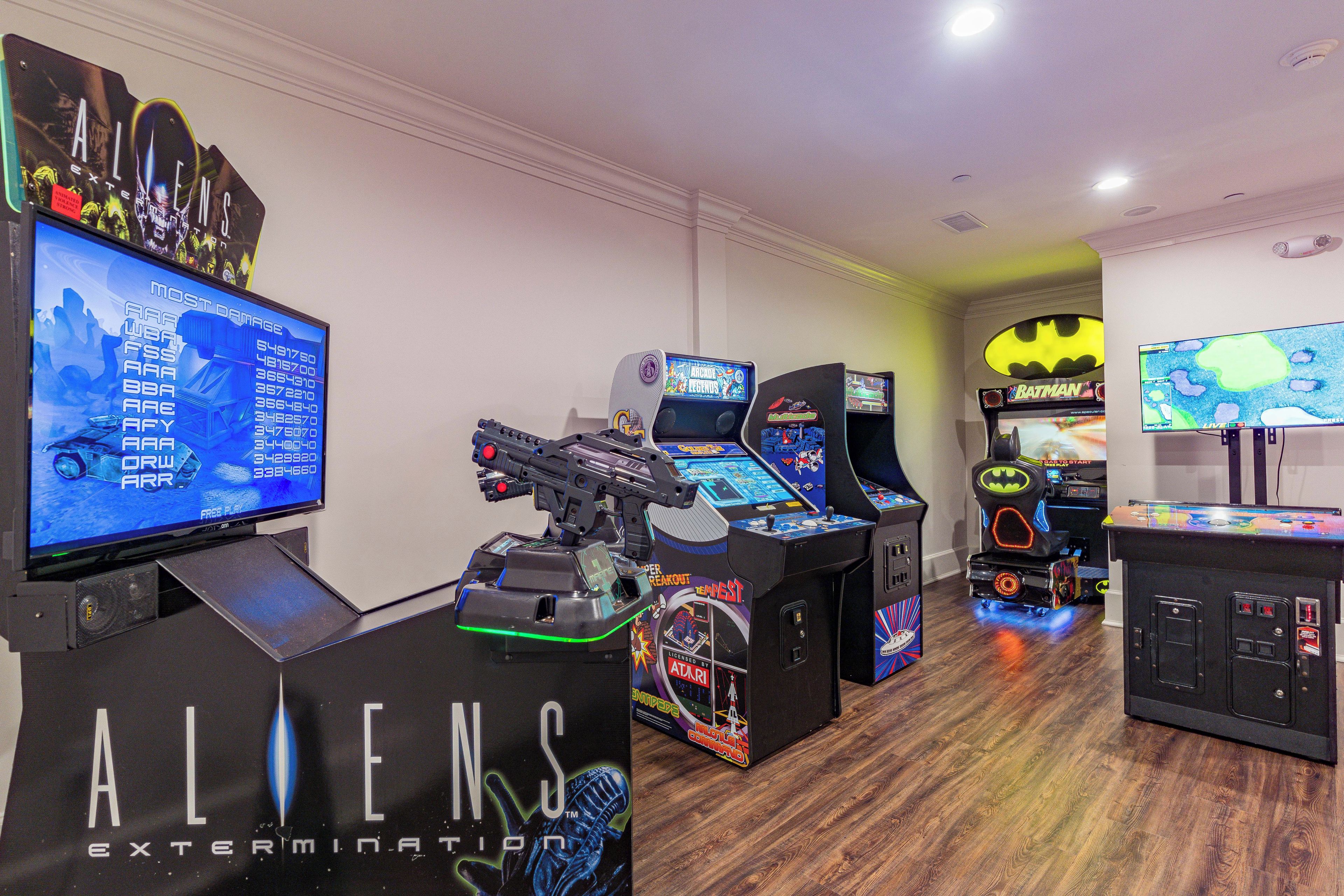A gaming arcade with various arcade machines, including titles like 'ALIENS' and 'Batman'.