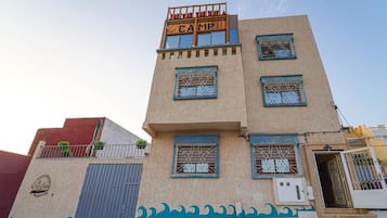 A multi-story building with a sign reading 'CAMP' on the top.