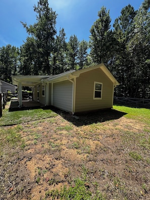 A single-story house with a covered porch and a small attached garage.