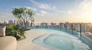 A rooftop infinity pool with a city view, surrounded by potted plants and a lounge area. - V3rso Nilo Square (Porto Alegre)