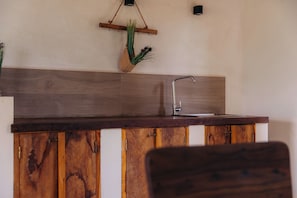 A kitchen with a wooden countertop, a stainless steel sink, and a hanging plant. - Romantic Villa Near Beach - AC, WiFi, Kitchen (Pwani Mchangani North Region)