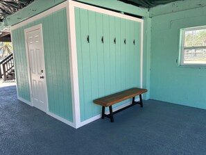 A room with a bench, a door, and a window. - Slice of Paradise: 2BR Bonita Beach Home with Gulf & Bay Views (Bonita Springs)
