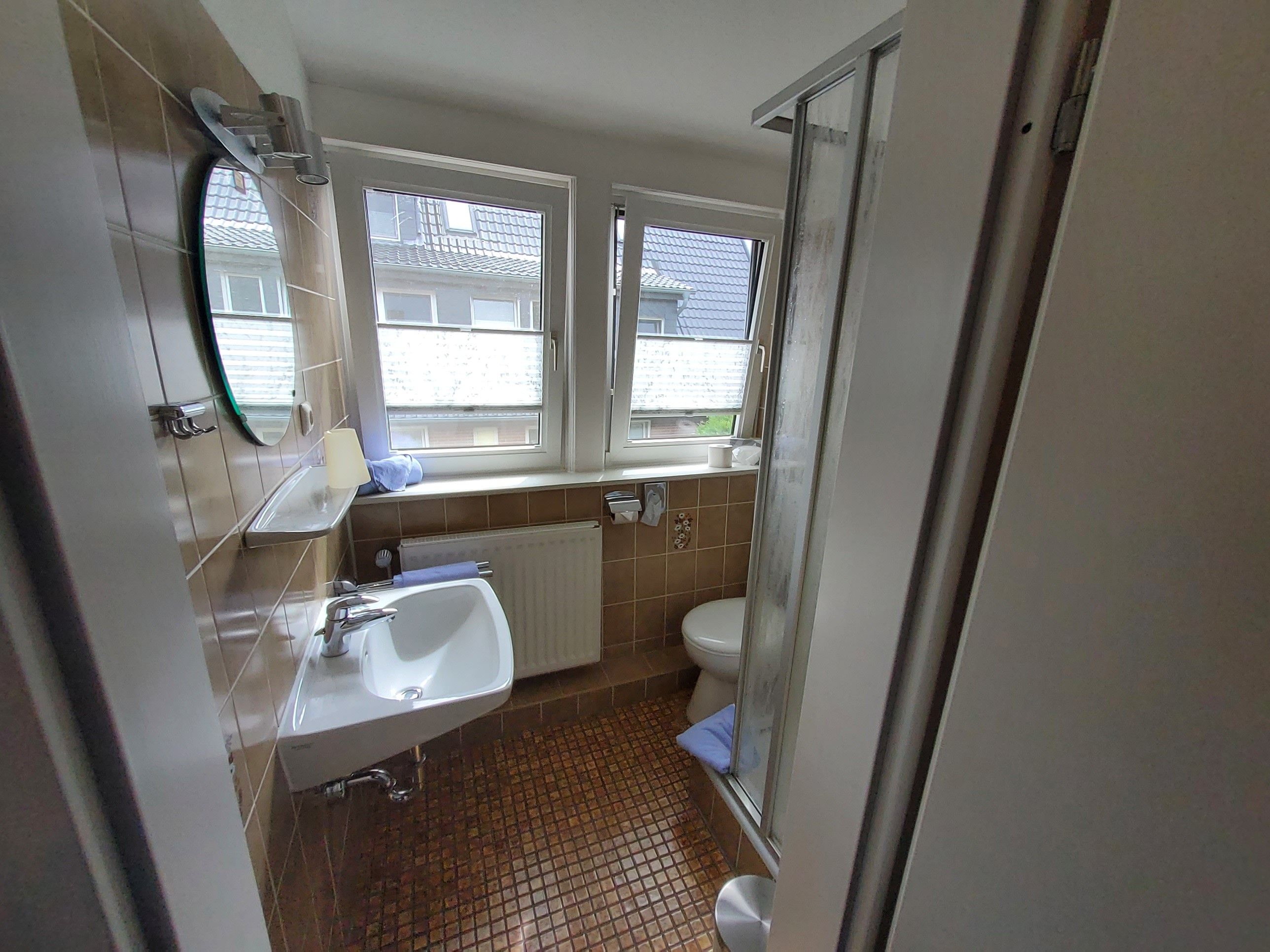 A bathroom with a sink, toilet, and shower.