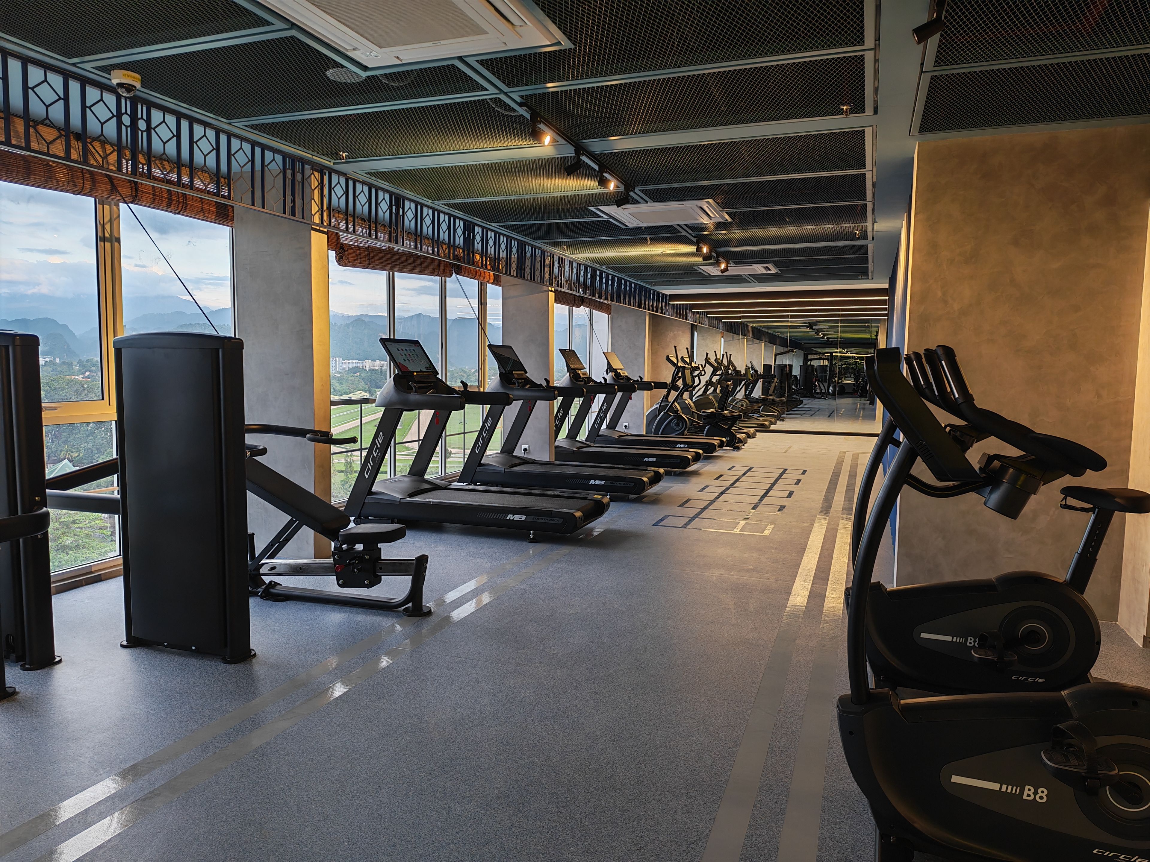 A gym with treadmills, stationary bikes, and weight machines.