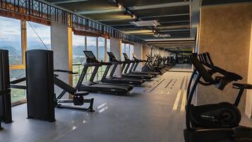 A gym with treadmills, stationary bikes, and weight machines.