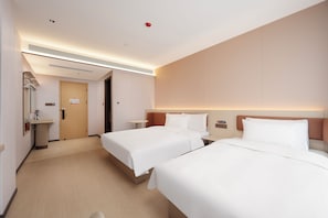 A hotel room with two beds, a bathroom, and a small table. - G Jinhua Hotel Apartments - Shanghai (Shanghai)
