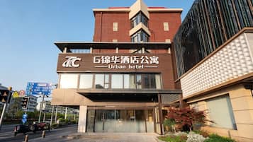 A modern urban hotel with a prominent entrance and signage.