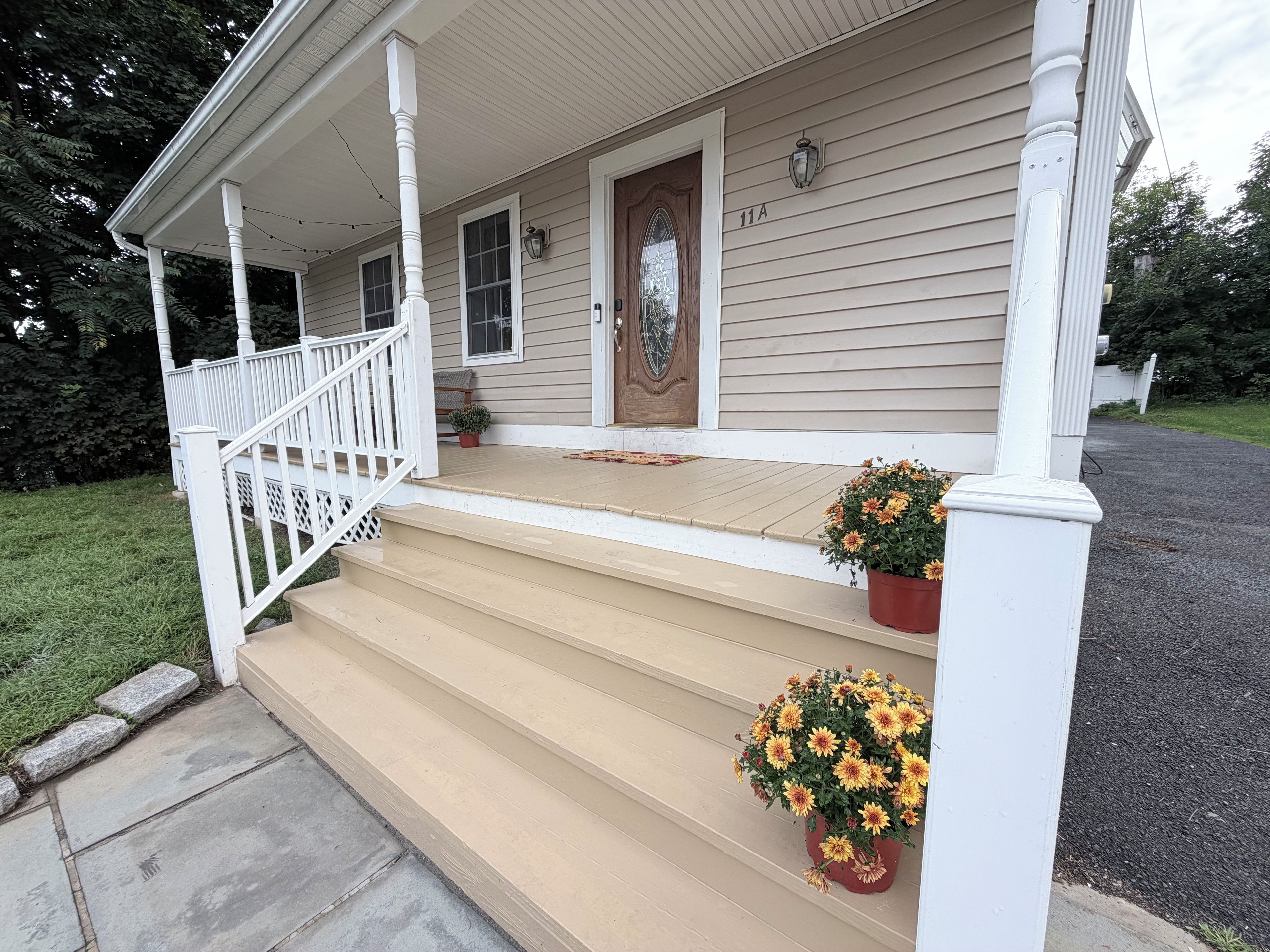 A house with a porch, steps, and a front door.