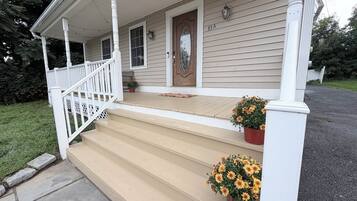 A house with a porch, steps, and a front door.