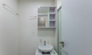 A small bathroom with a white sink, a mirror, and a medicine cabinet. - Studio in Bldg. w/ gym 150m From the Beach Ses0705 (Salvador)
