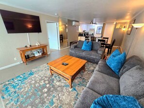 A living room with a sofa set, a coffee table, and a television. - Bay View Condo Near SeaWorld, San Diego (San Diego)